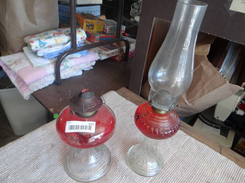 lot 819 image: 2 Vintage oil lamps one missing globe.