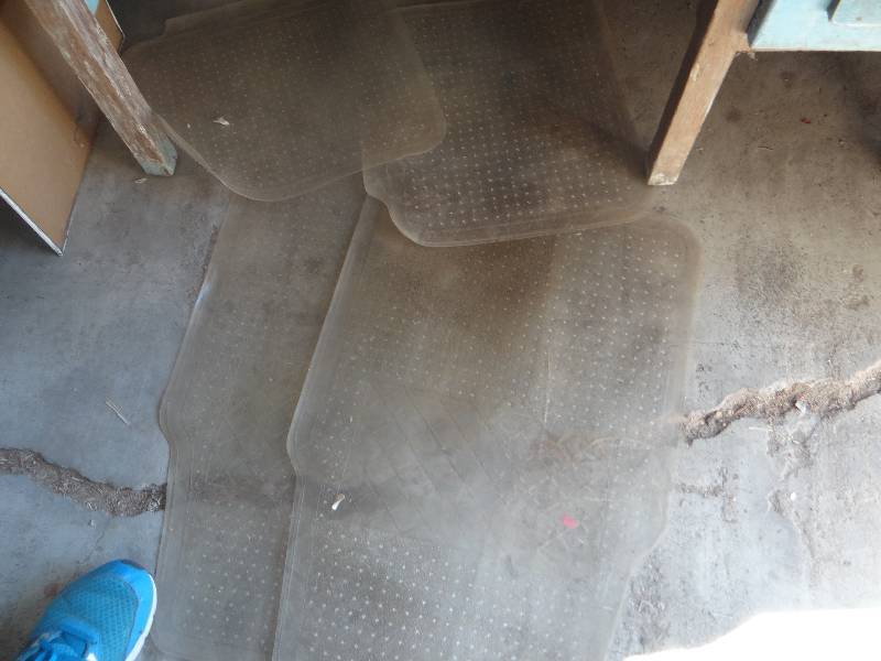 lot 848 image: Lot of automobile items, metal wheel chocks, floor mats, cup holders, jumper cables, and oil filter tools.