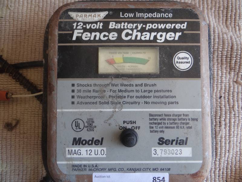 lot 854 image: 12V battery powered fence charger and tank heater.