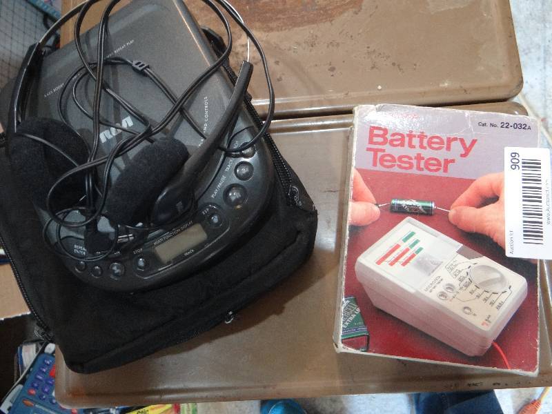 lot 909 image: Battery tester and portable CD player.