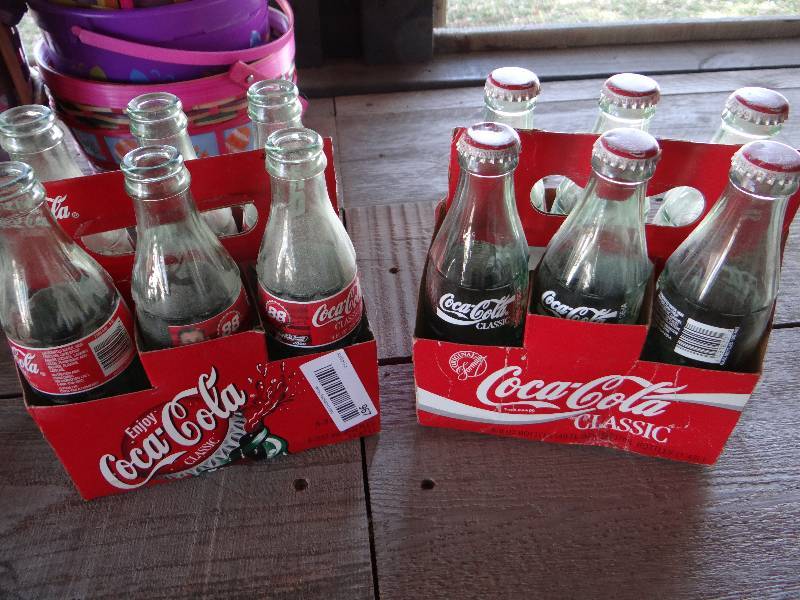 lot 967 image: Two 6pk of Coca Cola bottles.