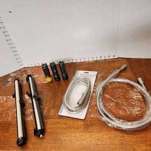 lot 312 image: Coleman flashlights (all work), car window shades and shower hose