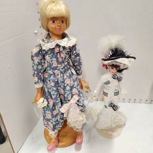 lot 450 image: Robert Raikes wood doll 18 tall and Barbie as Eliza Doolittle from My Fair Lady 13 tall, both with stands