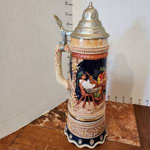 lot 600 image: Vintage German beer stein with pewter lid Swiss musical movement 12 tall