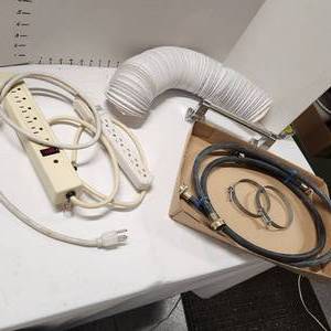 lot 698 image: 2 power strips, dryer vent hose, washer hoses and grab bar
