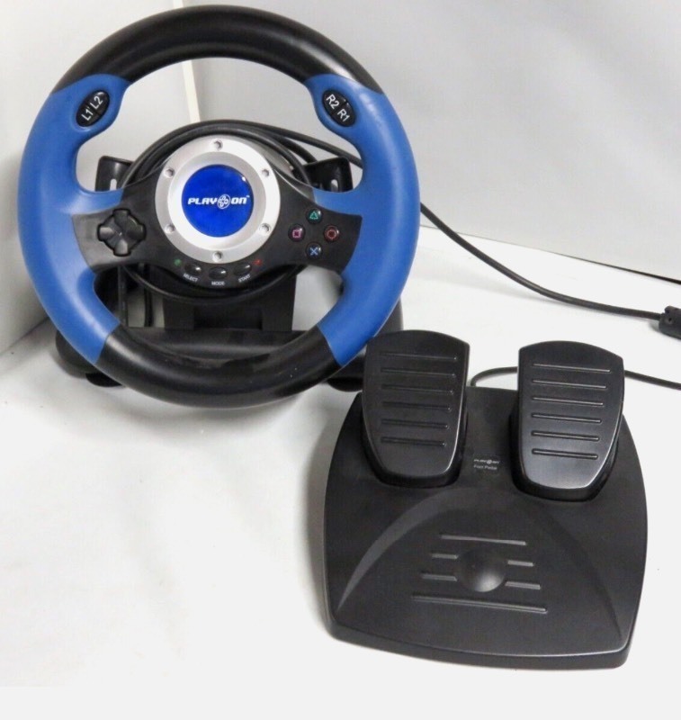 lot 164 image: New V8 Plus Racer, Play On Steering Wheel w Foot Pedals for PlayStation, Black Blue