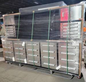 lot 250 image: Unused 10ft Stainless Steel Garage Cabinet Workbench w Wheels (30 Drawers & 2 Cabinets) - This Is The Perfect Addition To Your Workspace. It Is An All-In-One Workstation That Provides You With a Pegboard, Drawers, and Cabinets for Maximum Organization