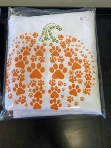 lot 2569 image: Fall items- (1) white pumpkin pawprint apron, (1) Medium T-shirt