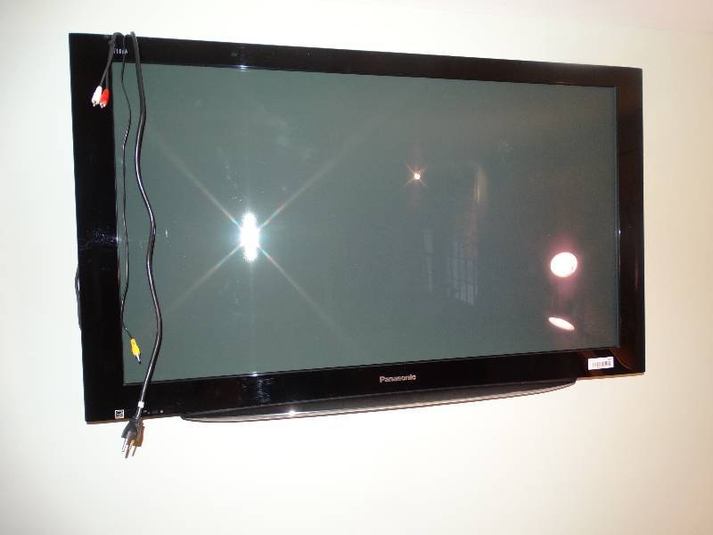 lot 417 image: Large Panasonic Flat Screen TV wWall Mount. Buyer Responsible for Removal & NOT damaging wall.