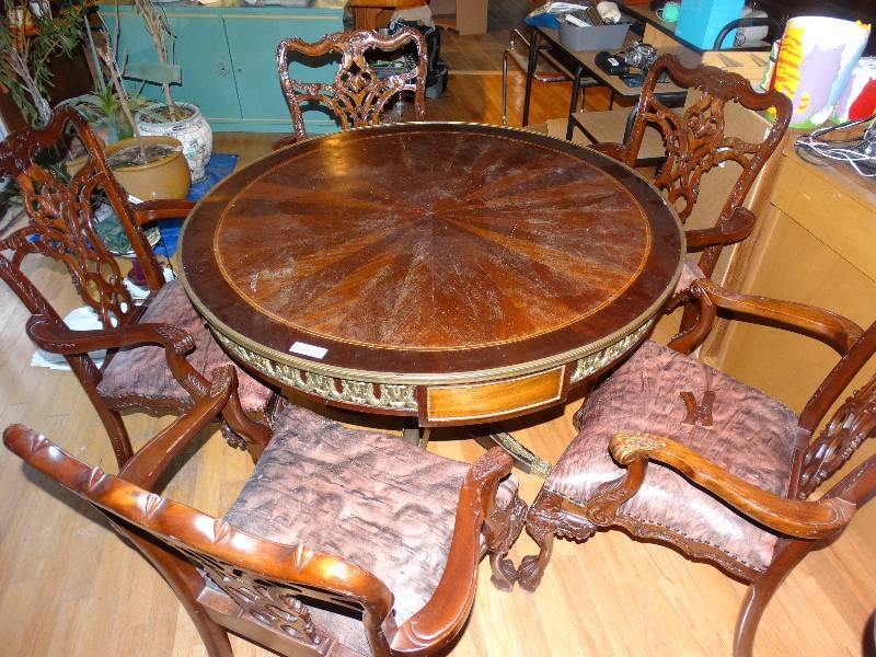 lot 454 image: Round Wood Table wBrass Feet & Adornment - Inlay Top.  With 5 Carved Chairs - some need TLC.