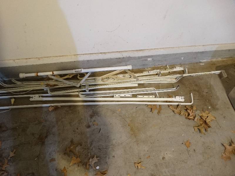 lot 987 image: Lot of Metal Curtain Rods, Adjustable Shower Rod, Metal Shelf Brackets.