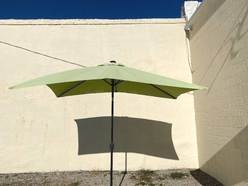 lot 254 image: Rectangular Patio Umbrella (Green) with a cast iron base