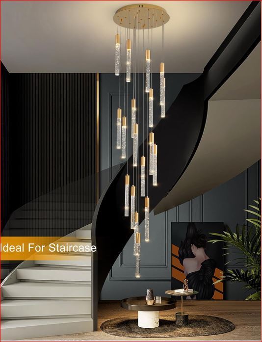 lot 2452 image: Eustance 18 light LED Crystal Chandelier with gold trim for tall ceilings. MSRP $389
