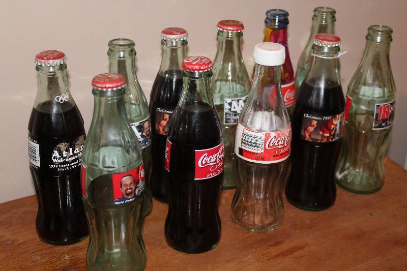 lot 5060 image: Lot of Coca Cola Bottles - Some Still Full