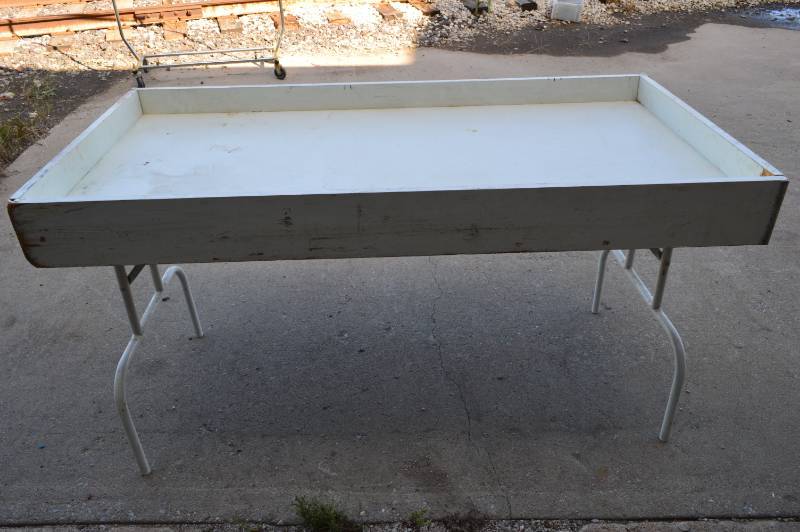 lot 3138 image: Merchandisedump table  with folding legs 60 x 30 x 33 tall (one end needs repaired)