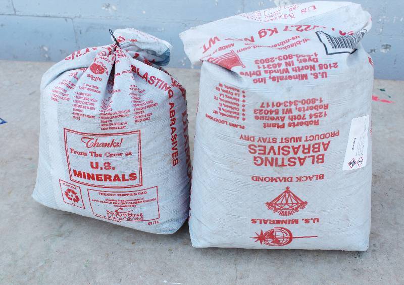 lot 3045 image: Blasting Abrasives- 50 pound bags. One unopened- other is about 80% full- Awesome
