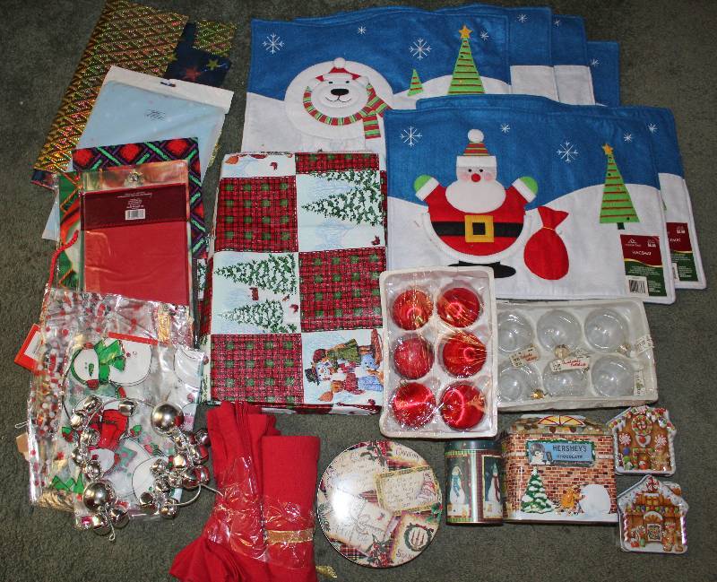 lot 8586 image: Lot of Assorted Christmas Decor - Placemats, Ornaments, Tins, Bells, Napkins, Table Cloth, Gift Bags, Etc...