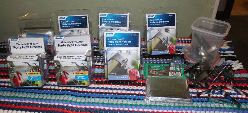 lot 8608 image: Packages of Party Light Holders & Metal Table Cloth Holders and Camper Emergency Blanket - Most items new