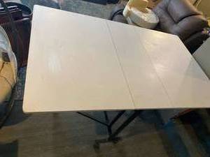 lot 33 image: Large fold down table on wheels