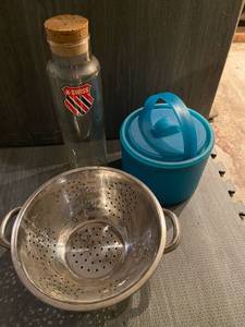 lot 111 image: Assortment of dishes- colander, Swiss bottle, blue storage container, plastic plates and snoopy bowl
