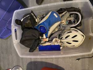 lot 316 image: Tote with biking supplies- helmet, face mask for cold weather or dust, assortment of travel bags