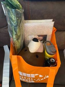 lot 339 image: Bag with a bear head, wedding photo album, love you more sign, water bottle, artificial greenery.