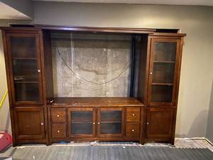 lot 342 image: Solid wood entertainment center- comes with additional shelf in the center for storage
