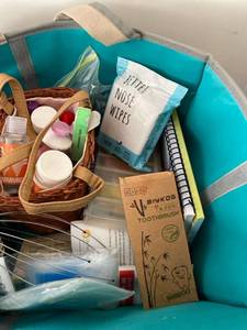 lot 2677 image: Healthcare bag- pill holders, kids bamboo toothbrushes, nose wipes, hand cream and hand sanitizer, head massager, etc.
