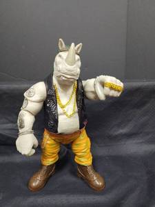 lot 21 image: Lonfisk Rhino Action Figure with Leather Vest and Gold Chains