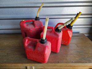 lot 724 image: Plastic Gas Cans with Spouts - Set of 3 and 2gallon can