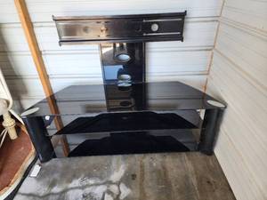 lot 814 image: Modern Black Glass TV Stand with Integrated Mount (55 at widest part of base)