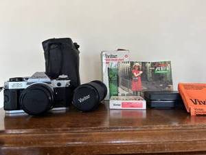 lot 7511 image: Vintage Canon AE1, lenses and misc