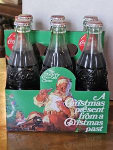 lot 7735 image: Vintage Coca-Cola Christmas Carrier with Classic Glass Bottles