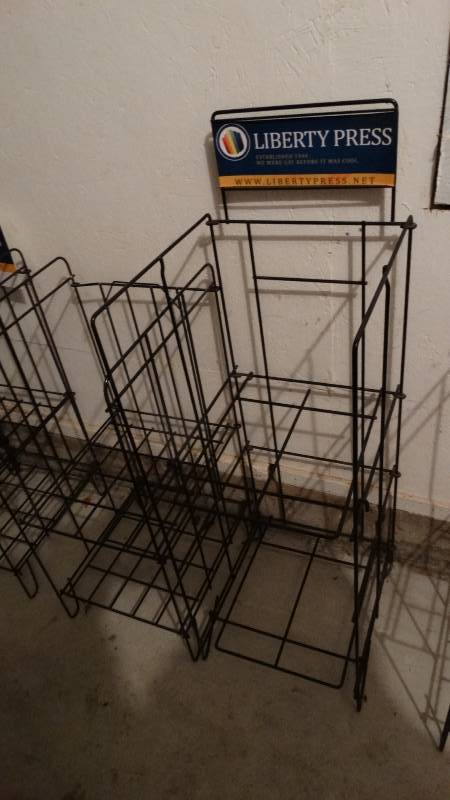 lot 812 image: 2 folding Liberty Press magazine racks