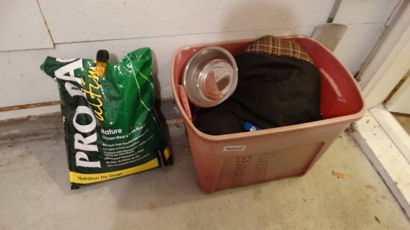 lot 841 image: Tote w assorted dog supplies & partial bag of dog food
