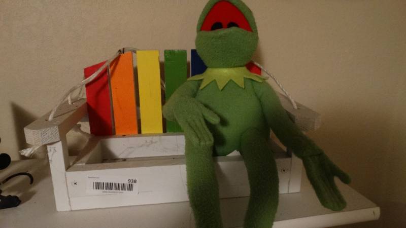 lot 938 image: Kermit the frog on wood swing