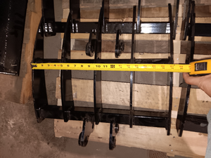 lot 1343 image: Unused 19in Wide Backhoe Rake Attachment for Mini Excavator - Easily Attach to Your Excavator and Get the Job Done with Ease. It is Compatible with Most Mini Excavators. The Hole Diameter is 25 mm0.98 inch