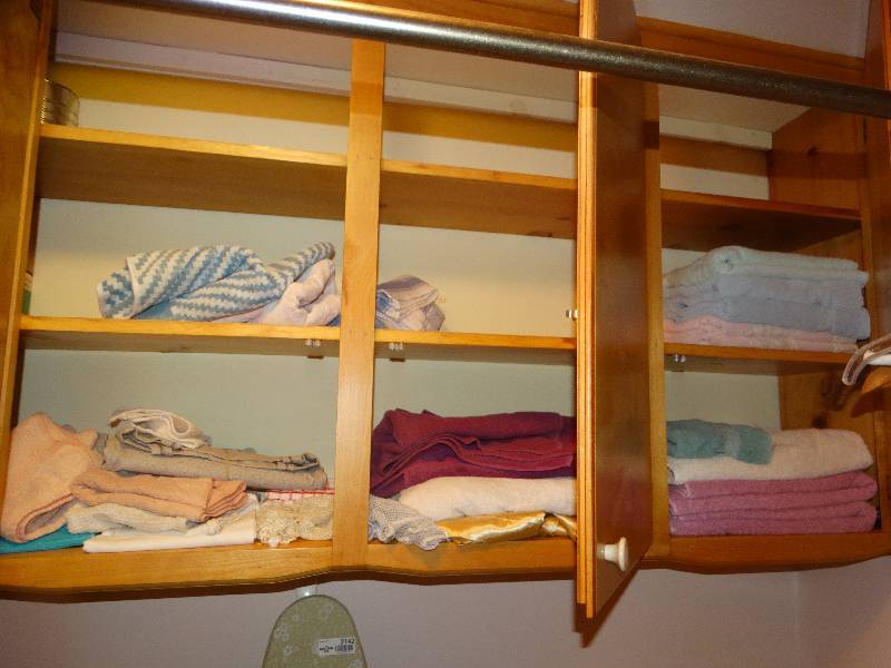 lot 2143 image: All TowelsLinens, Light bulbs, metal cans, in cabinets and hangers on clothes rod.