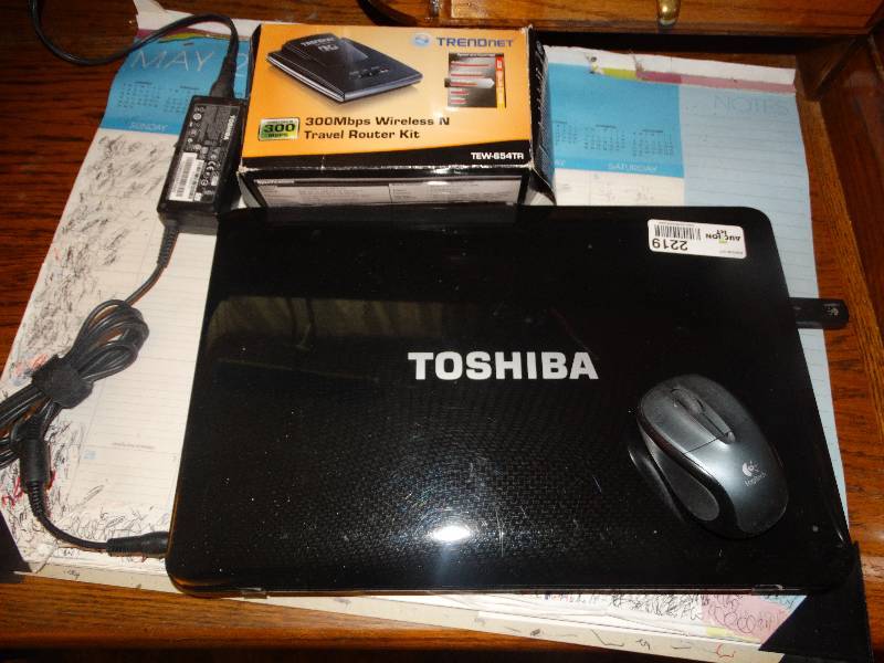 lot 2219 image: Toshiba Laptop, Cord, Wireless Mouse, Travel Router & Desk Pad.