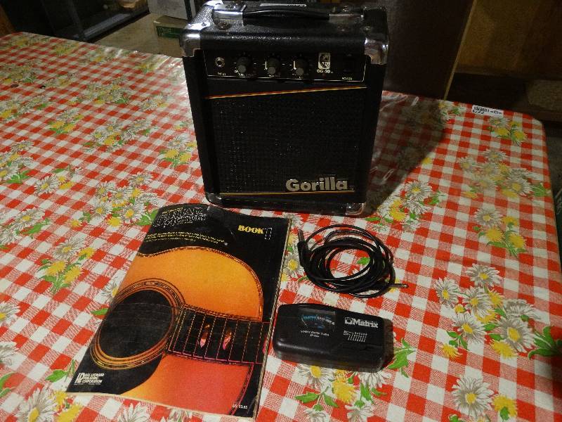 lot 2272 image: Small Gorilla GG-20 Amp WCord, Matrix Guitar Tuner, Guitar Method Book.