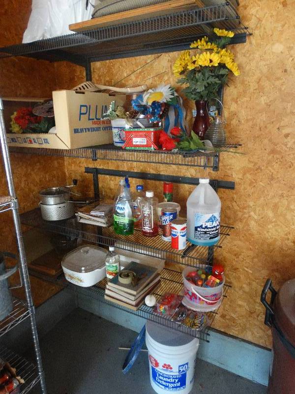 lot 2330 image: All Items on & under Metal Wall Shelves. Shelves NOT included. Cookware, Books, Bucket WBows, Cleaners, Soap, Photo Albums, Flowers, Yard Stakes, Outdoor Chair Cushions, Curtain Rods, Wash Bucket, Decor.
