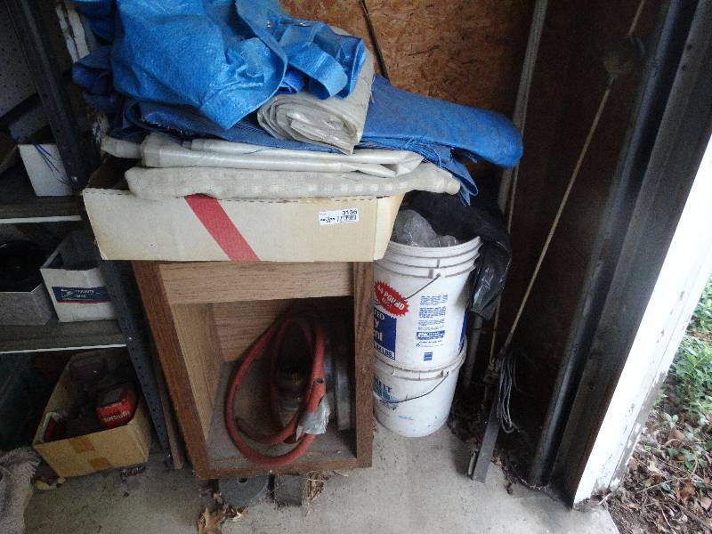 lot 3136 image: Wood cabinet, tarps, buckets and misc.