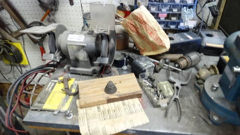lot 3087 image: bench grinder and contents on top of bench, not storage cabinets or vice.