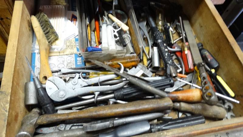 lot 3089 image: Contents of drawer. Pliers, screw drivers, tap and die set, and other hand tools.