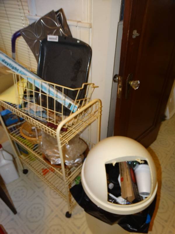 lot 582 image: Small metal rack w contents- bug spray swifter misc.