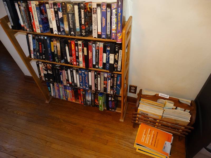 lot 595 image: Wood magazine rack w magazines & shelf w VHS tapes