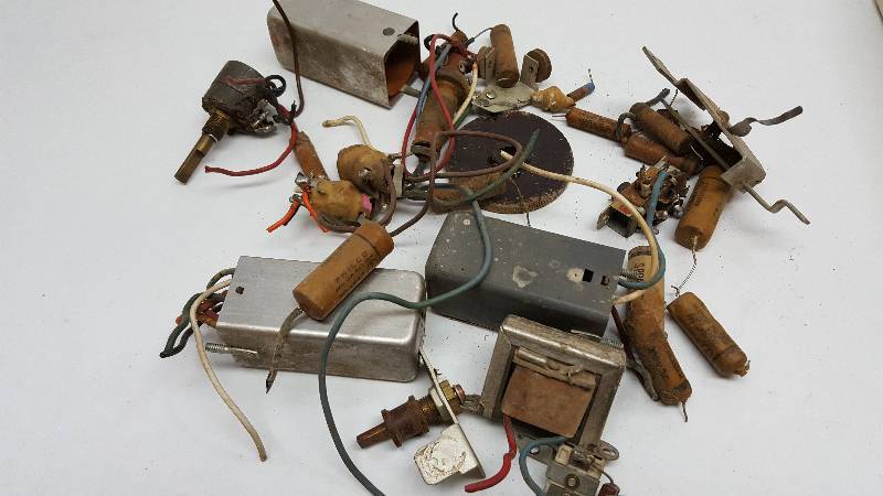 lot 5366 image: Found under the old Tinkerers work bench is this box of electronic pieces.  Look real close, I think I see something you might need later