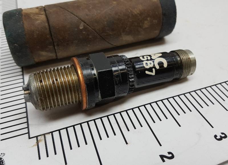 lot 5564 image: Its new but real old is this Collectable AC military or Warbird prop job air plane spark plug with the tube used to store it in for many years.