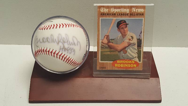 lot 1131 image: Brooks Robinson Autographed Major League Orioles Logo Baseball w Display Stand & COA