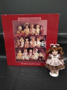 lot 497 image: NIB Anne Geddes 550 Piece Jigsaw Puzzle and Porcelain Doll with Stand (6 inches)